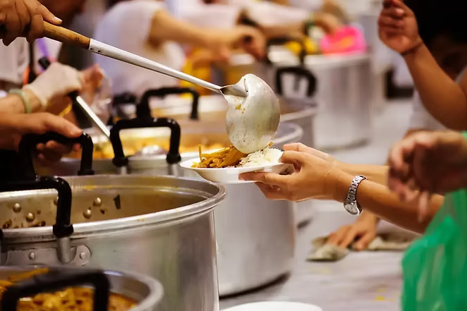 Volunteers serving meals at the community soup kitchen